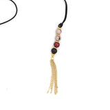 Faire Collection Cannes Lariat in burgundy, featuring a stylish jewelry necklace with intricate detailing and a sleek lariat design.