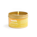 Kandu cardamom spice candle in a yellow tin on a white background