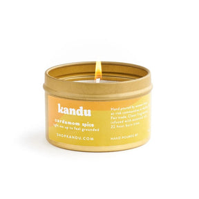 Kandu cardamom spice candle in a yellow tin on a white background