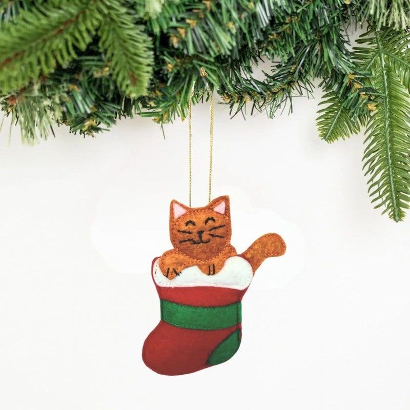 Upavim cat ornament hanging in a stocking, featuring a playful feline design perfect for holiday decor.