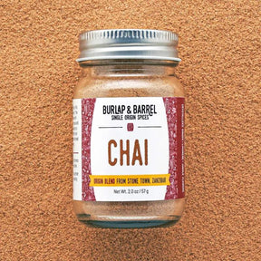 Burlap & Barrel chai spice blend featuring a mix of cinnamon, ginger, cardamom, and cloves in a glass jar.