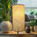Eangee Cocoa Leaf Cylinder Table Lamp in natural finish, 12-inch height with intricate leaf design, perfect for ambient lighting.