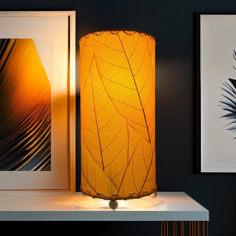 Eangee Cocoa Leaf Cylinder Table Lamp in orange, 12-inch tall with a detailed leaf design and warm ambient glow.