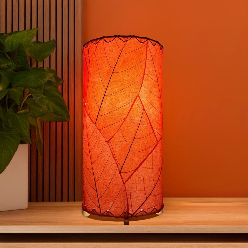 Eangee Cocoa Leaf Cylinder Table Lamp in red, 12-inch height, with intricate leaf design and warm lighting.