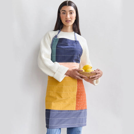 Anchal colorblock organic cotton bib apron with adjustable neck strap and front pockets, ideal for cooking or gardening.