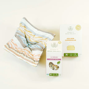 Striped fabric and Women's Bean Project packaging on a light background