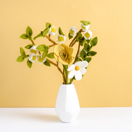 Eco-friendly felt flower arrangement in a ceramic vase displaying various colors and textures