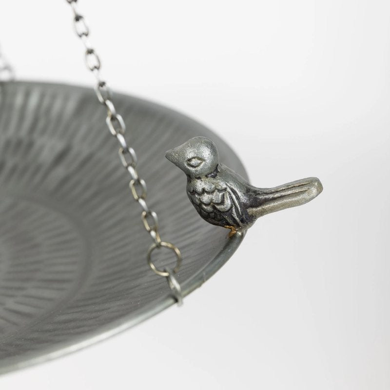 Silver bird-themed bird bath on a white background