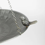 Silver bird-themed bird bath on a white background