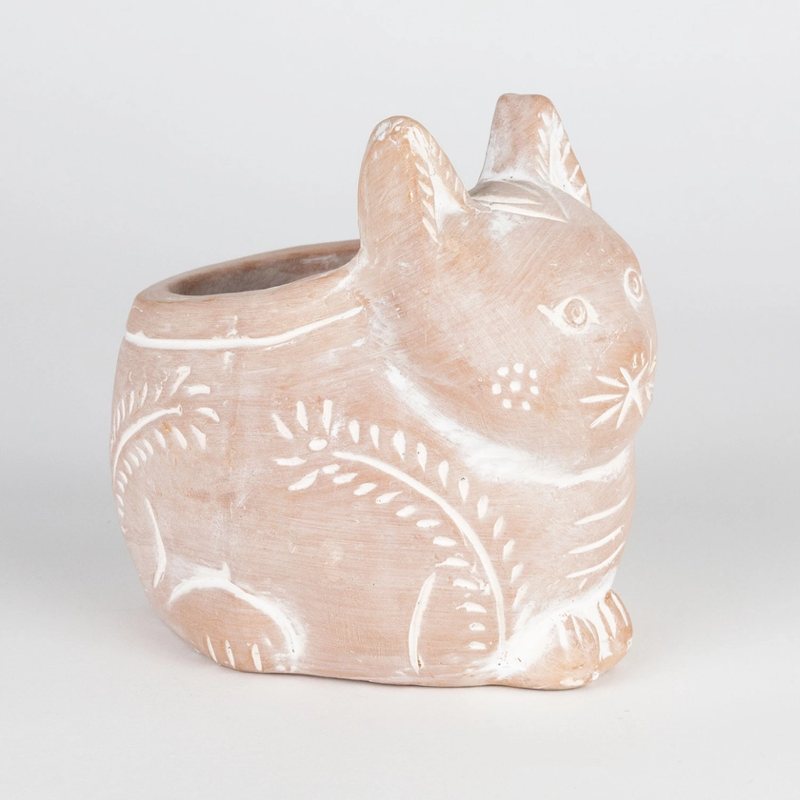 Ceramic cat-shaped planter with decorative patterns on a light gray background