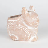 Ceramic cat-shaped planter with decorative patterns on a light gray background