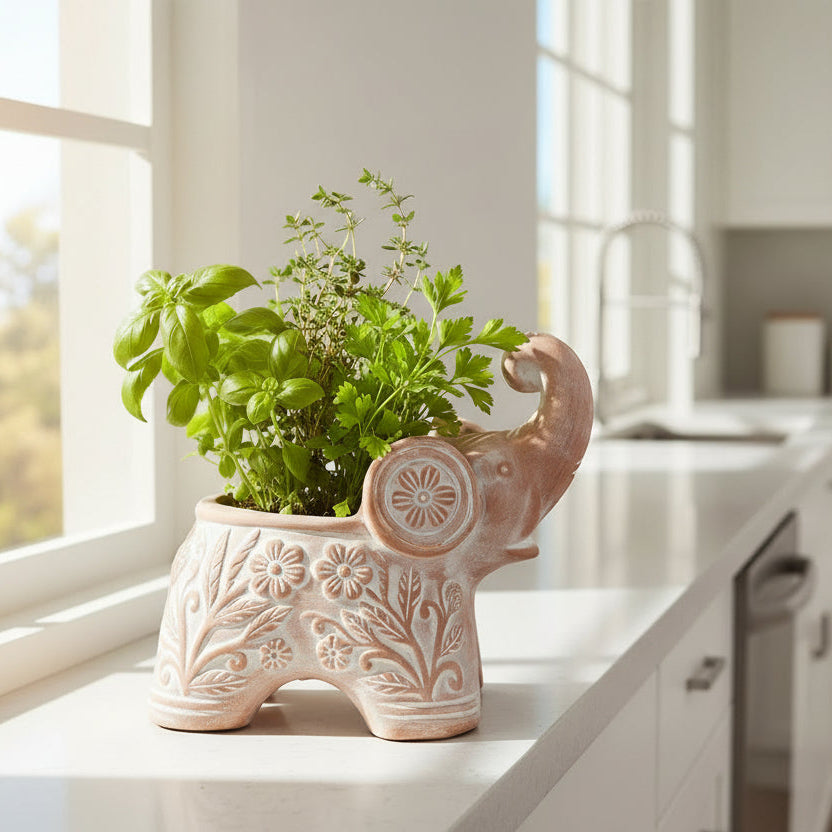 Decorative elephant-shaped planter with herbs on a windowsill.