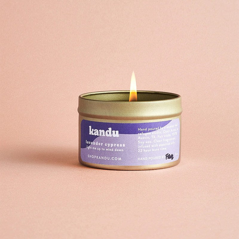 Kandu lavender candle with a purple label on a pink background