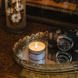 lavender cyprus candle on a metal try with a camera