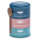 Justea tea canisters with wooden spoon on a white background