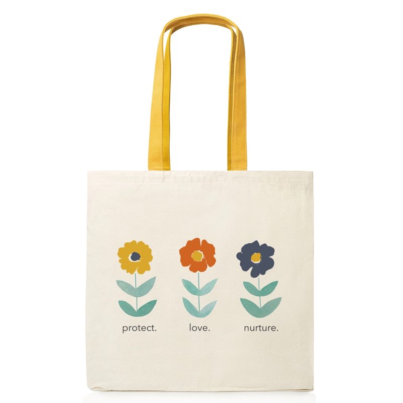 Tote bag with floral designs and text on a white background