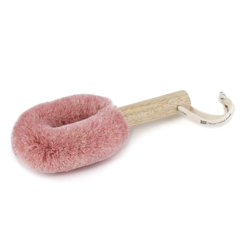 Pink spa brush with wooden handle on a white background