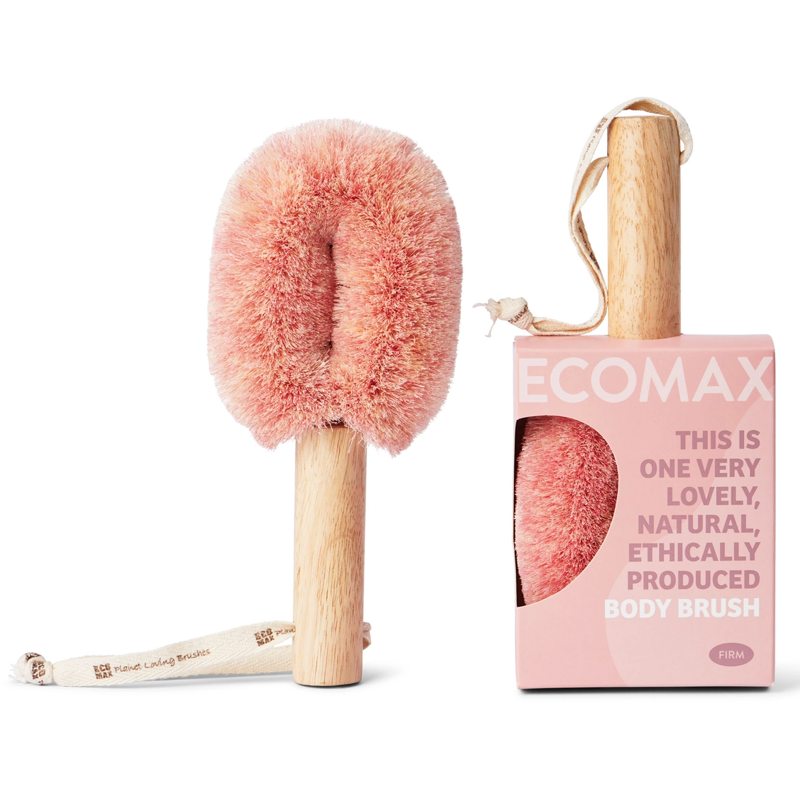 Body brush with pink bristles and wooden handle next to its packaging on a white background