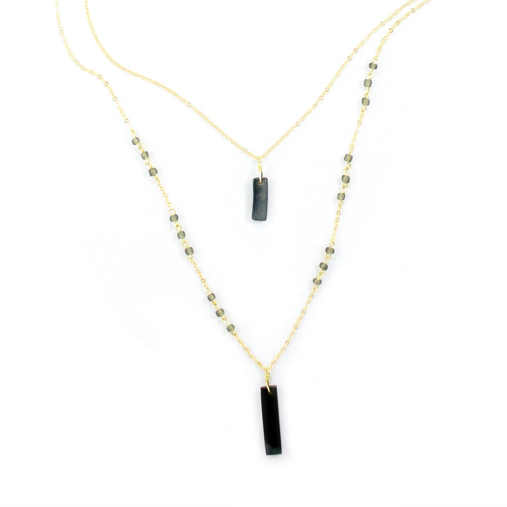 Allie Necklace in cool gray from Faire Collection featuring a slim chain and minimalist pendant for a modern, elegant look.