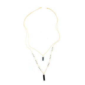 Faire Collection Allie Necklace with a smooth, cool gray pendant on a delicate chain, modern jewelry accessory for stylish looks.
