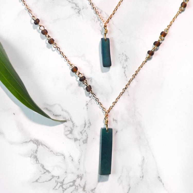 Allie Necklace by Faire Collection with a cool gray pendant on a fine chain, stylish jewelry accessory for everyday wear.