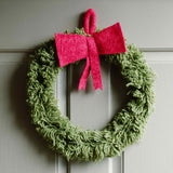 Large decorative felt wreath with lush greenery and a red bow, ideal for holiday or seasonal decoration.