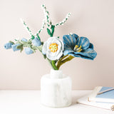 Colorful felt flower bouquet with blue, pink, and yellow blooms from Fair Trade Winds, arranged in a charming display.