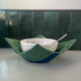 Global Mamas Eclipse Green bowl cozy with a vibrant green fabric cover designed to protect hands from hot bowls.