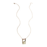 Elegant bridge pendant from Faire Collection, featuring a sleek design with a delicate chain and intricate detailing.