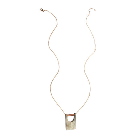 Elegant bridge pendant from Faire Collection, featuring a sleek design with a delicate chain and intricate detailing.