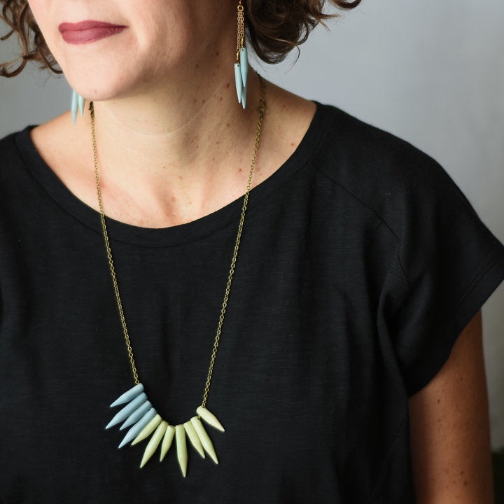 Faire Collection Brooklyn Necklace in vibrant blue with a bold, handcrafted design featuring a sleek, modern pendant.