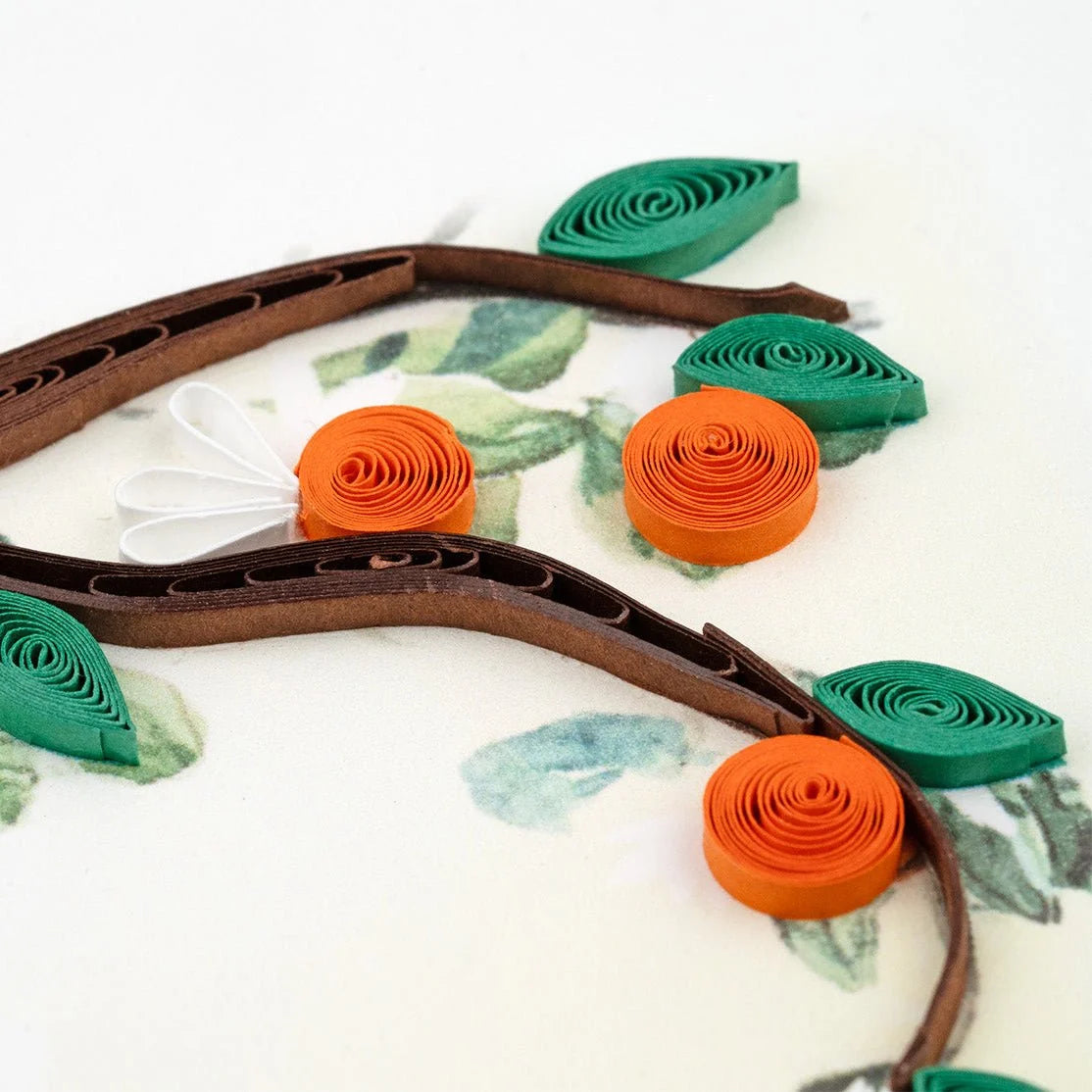 Close-up of Quilling Card featuring a detailed cat and orange branch design with intricate paper quilling artwork.