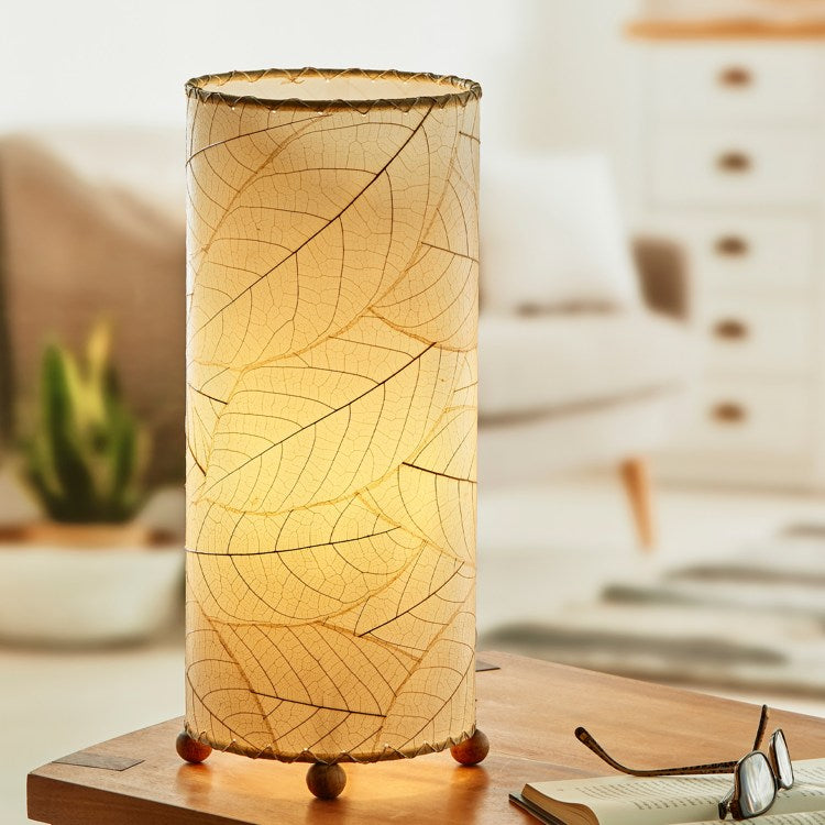 Eangee cocoa leaf cylinder lamp with natural leaf design, showcasing intricate leaf patterns and warm ambient lighting.