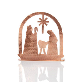 Copper tea light holder featuring a detailed nativity scene, crafted by Serrv, perfect for gentle holiday or spiritual ambiance.