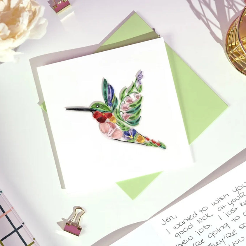 Decorative floral hummingbird quilling card featuring intricate paper quilling art with colorful floral and bird designs.