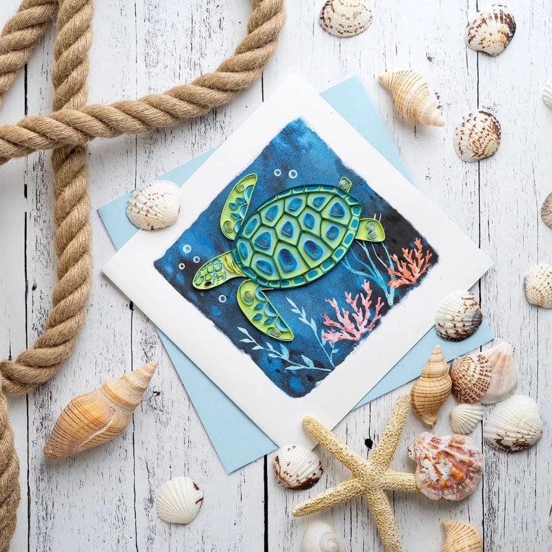 Decorative sea turtle quilling card featuring intricate paper quilling design on a white background.