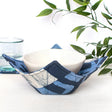 navy bowl cozy with a block print design, made to keep your microwave-safe bowls warm and protected.