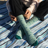 Pair of white cotton socks with whale protection logo from Conscious Step, designed to support whale conservation efforts.