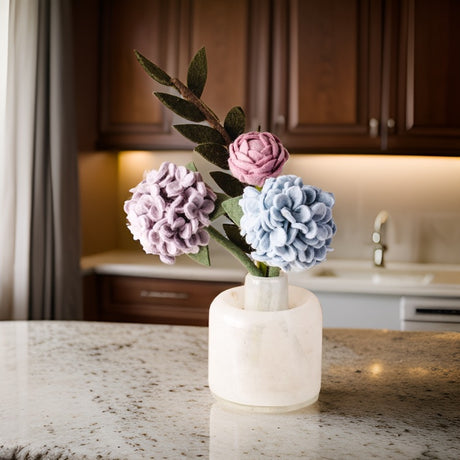 Beautiful hydrangea felt flower bouquet displayed in a vase on a modern kitchen island