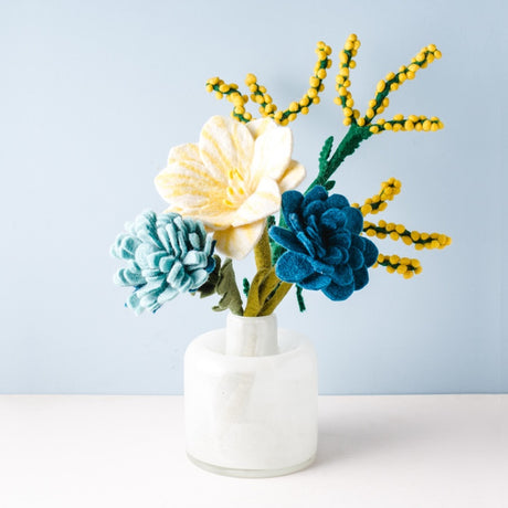 Eco-friendly felt flower arrangement in a marble vase displaying various colors and textures