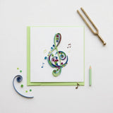 Blue treble clef quilling card featuring intricate paper filigree art, perfect for musical or artistic occasions.
